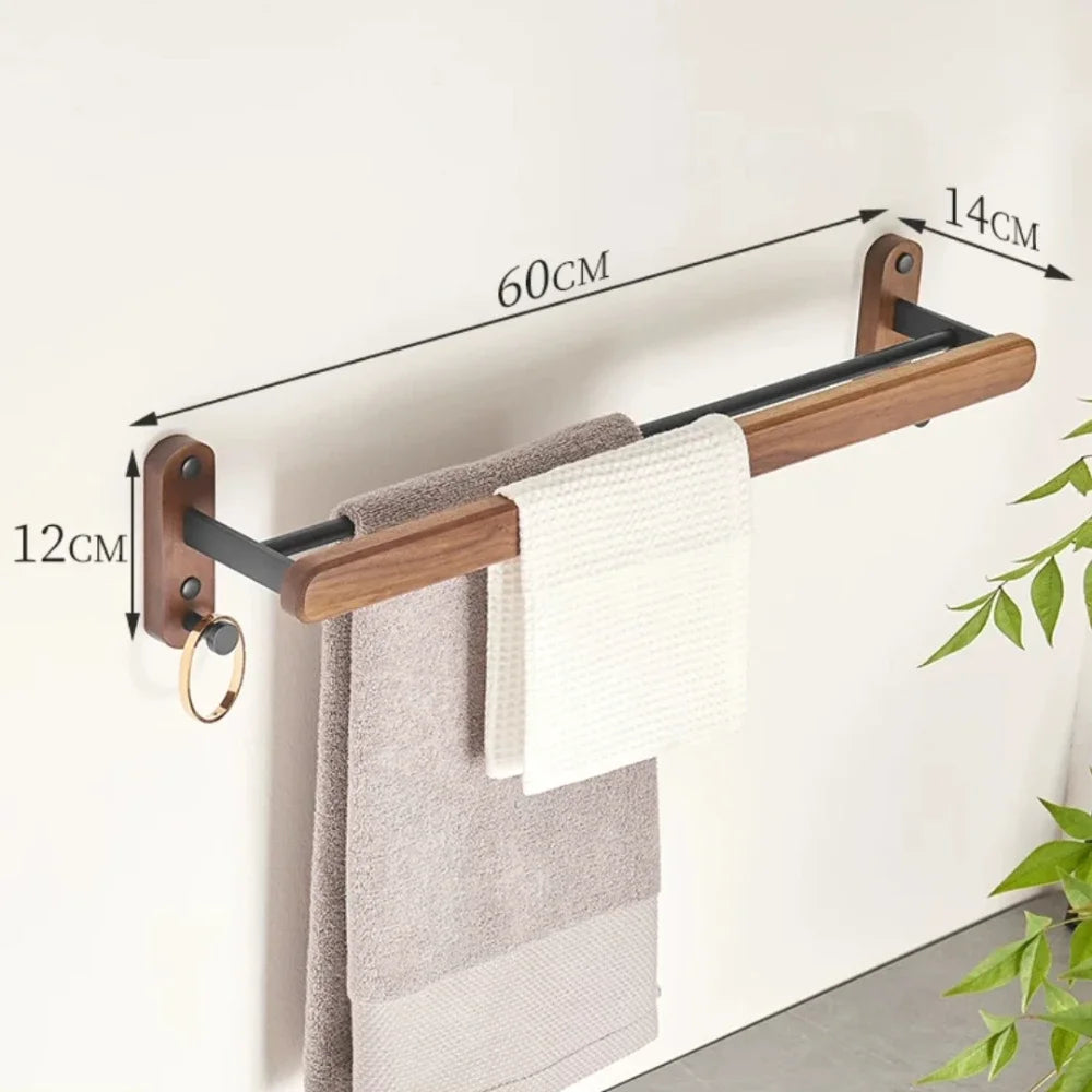 Towel rack with dimensions and towels hanging on it against a white wall.