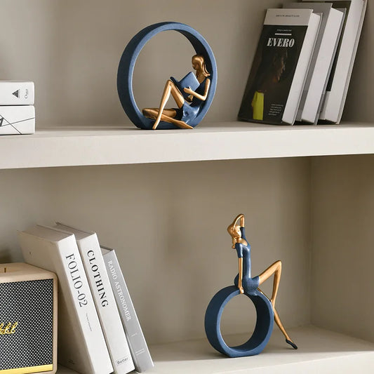 Decorative statues on a shelf with books