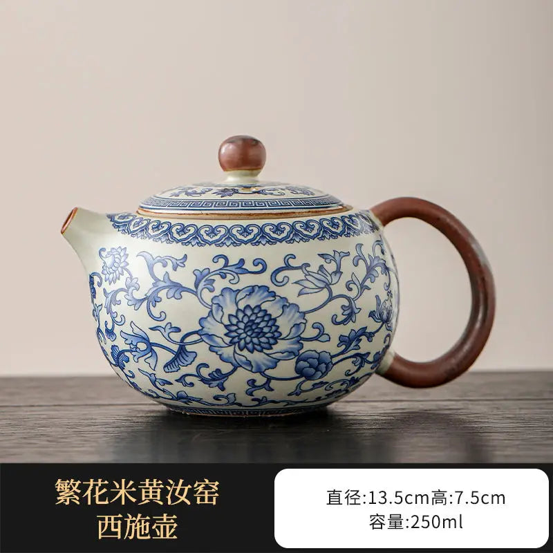 Ceramic teapot with blue floral patterns on a wooden surface