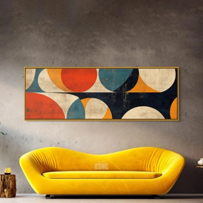 Yellow sofa in front of a wall with a colorful abstract painting