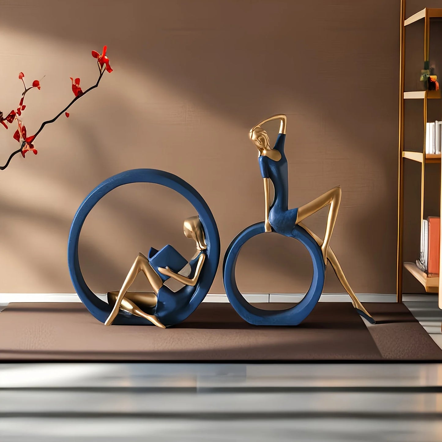 Decorative sculpture of two people on a bicycle with a book, placed indoors.