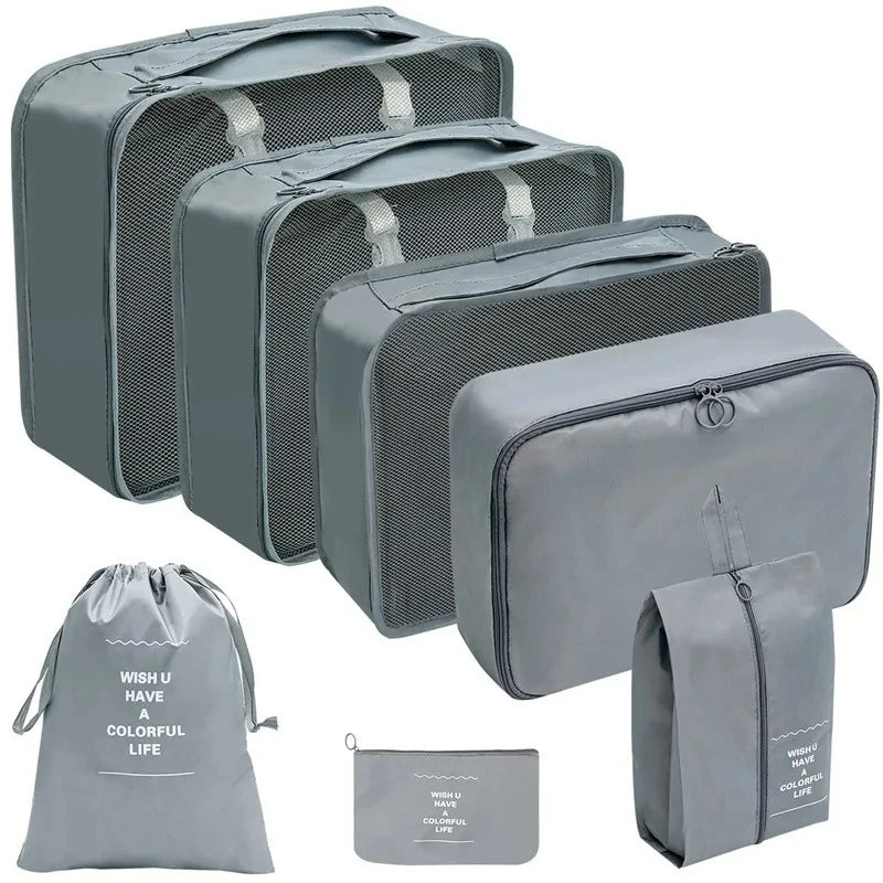 Set of gray packing cubes and travel bags on a white background