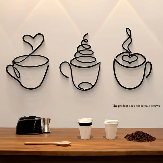 Minimalist metal coffee cup wall art displayed above a wooden counter in a modern kitchen setting