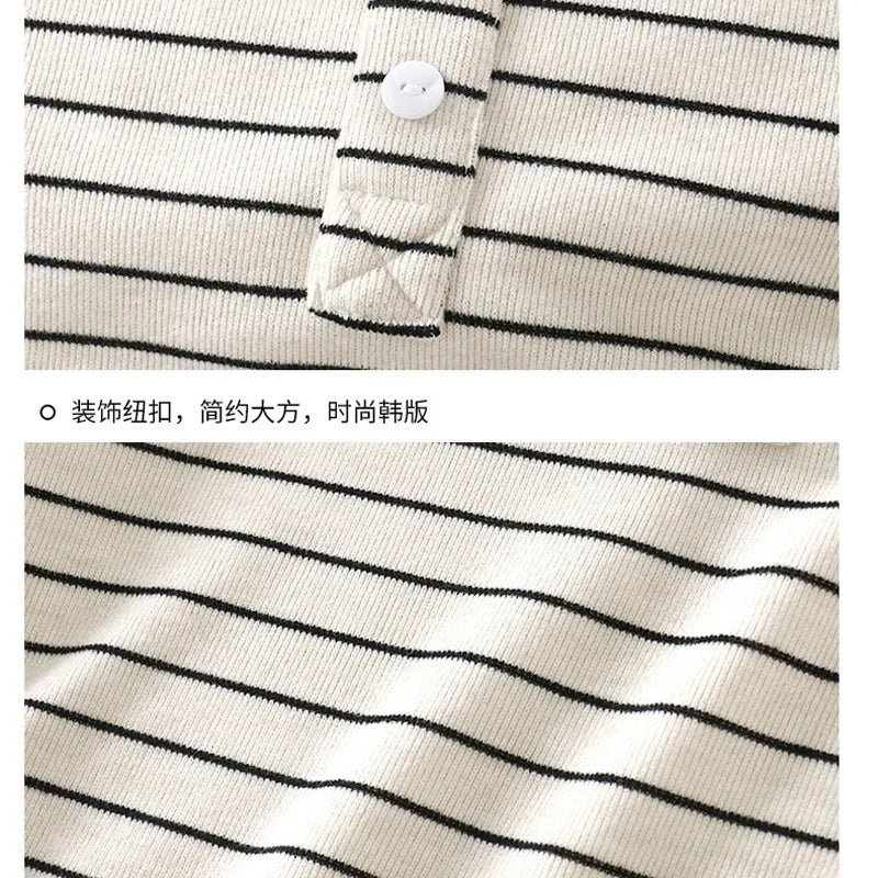 Close-up of a striped shirt with a button detail on a plain background