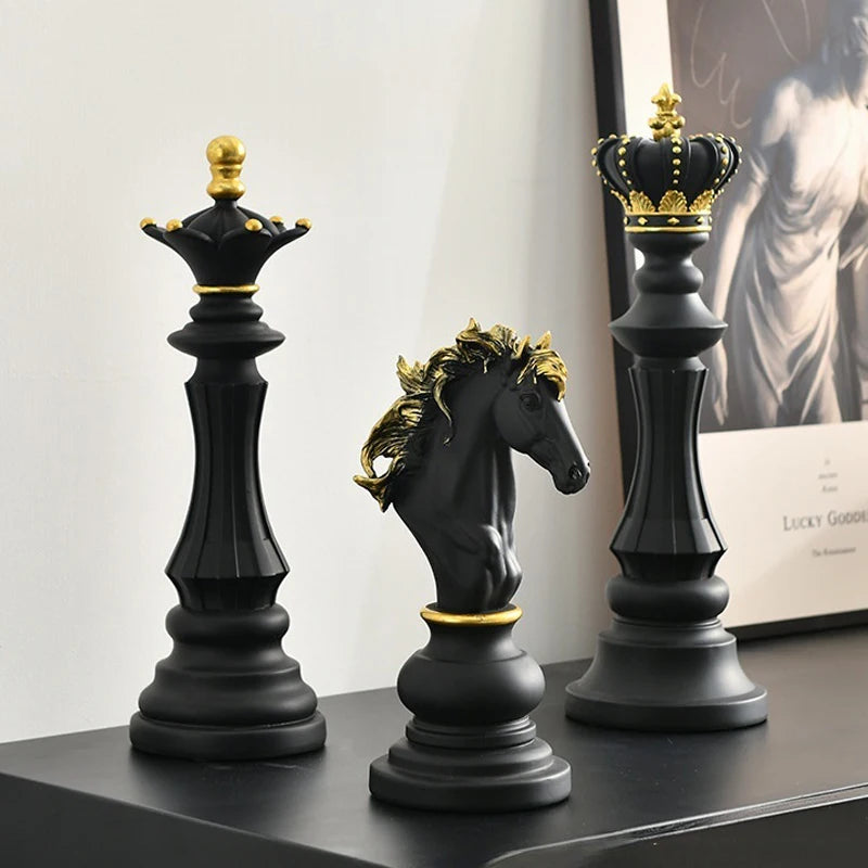 Decorative chess pieces with crowns on a shelf