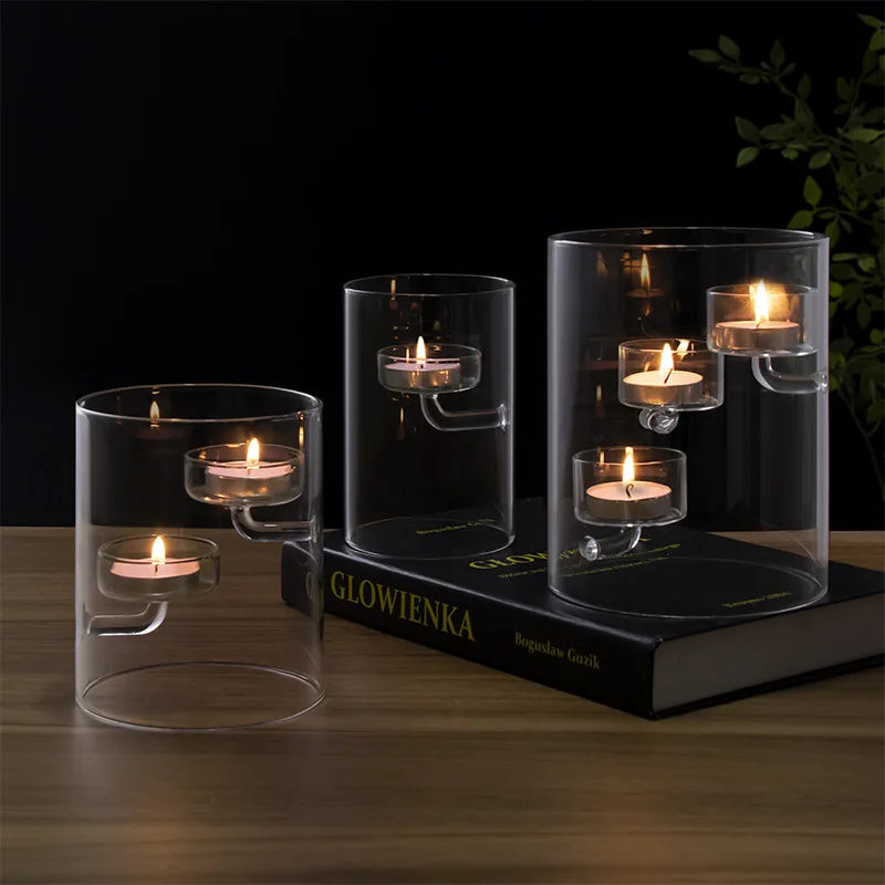 Modern cylindrical glass candle holders with suspended tealight platforms, available with clear or amber-toned candle cups and one, two or three candle platforms.