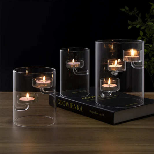 Modern cylindrical glass candle holders with suspended tealight platforms, available with clear or amber-toned candle cups and one, two or three candle platforms.
