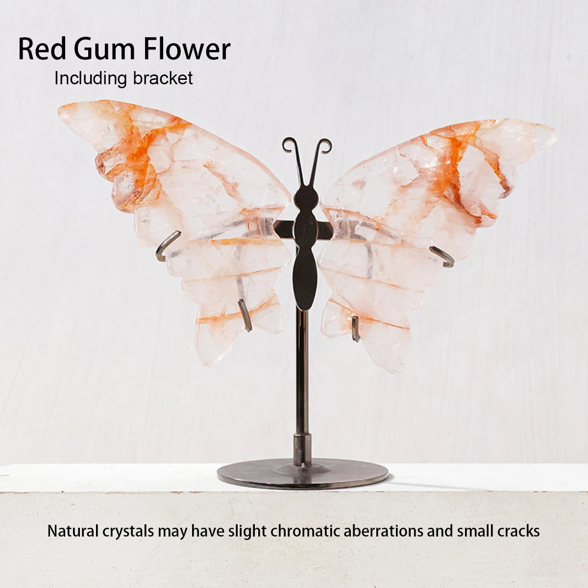 Butterfly-shaped crystal sculpture on a stand with 'Red Gum Flower' text and bracket mention.