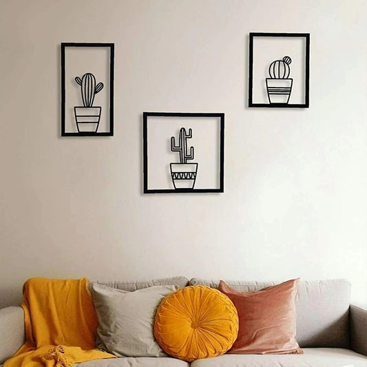 Three piece black metal cactus wall art set arranged side by side in modern minimalist style