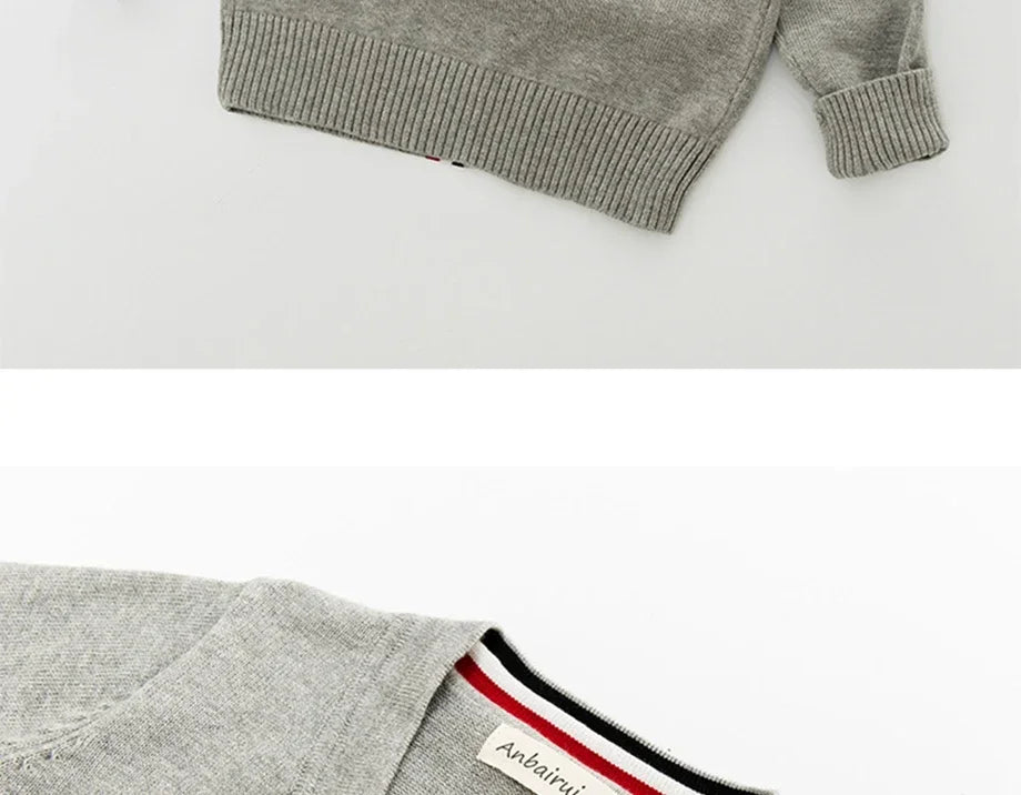 Grey sweater with a brand label on a white background