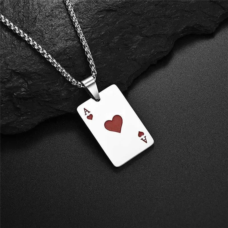 Silver necklace with a playing card pendant featuring an Ace of Hearts on a dark stone surface.