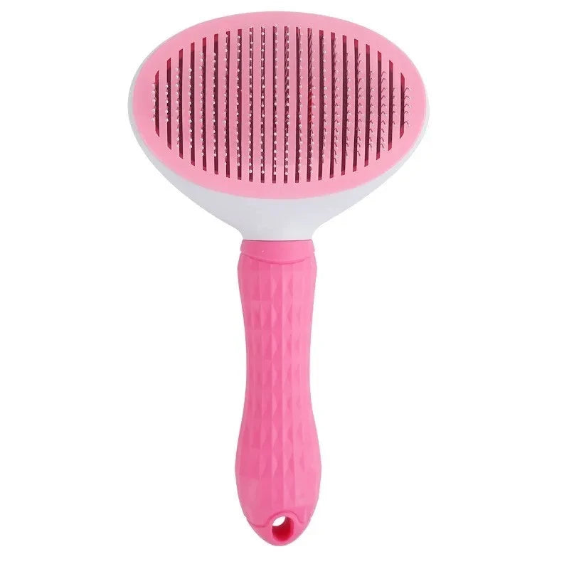 Pink pet grooming brush on a white background