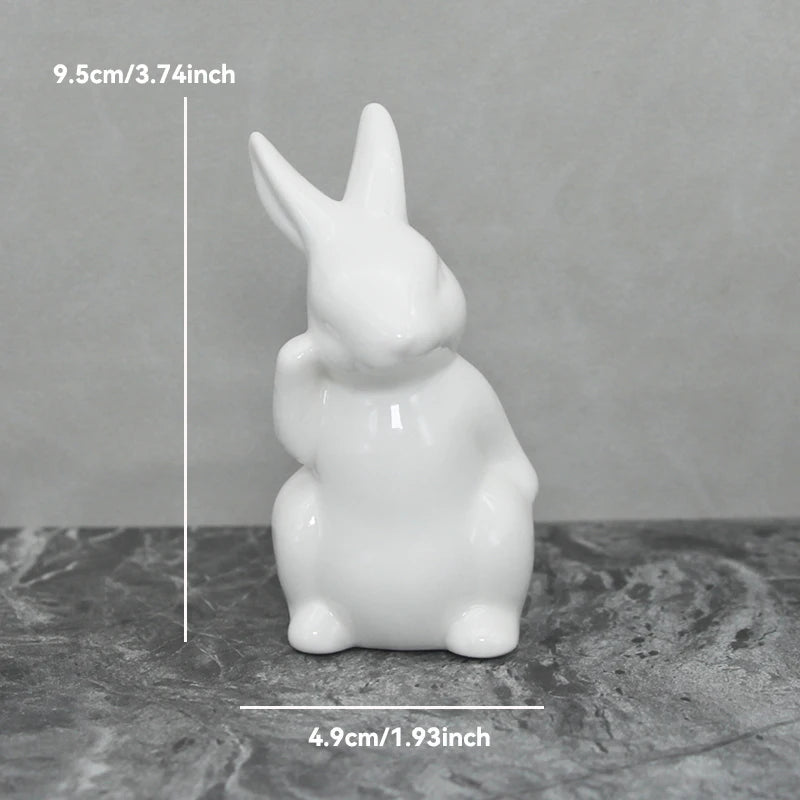 White ceramic rabbit figurine with measurements on a gray background