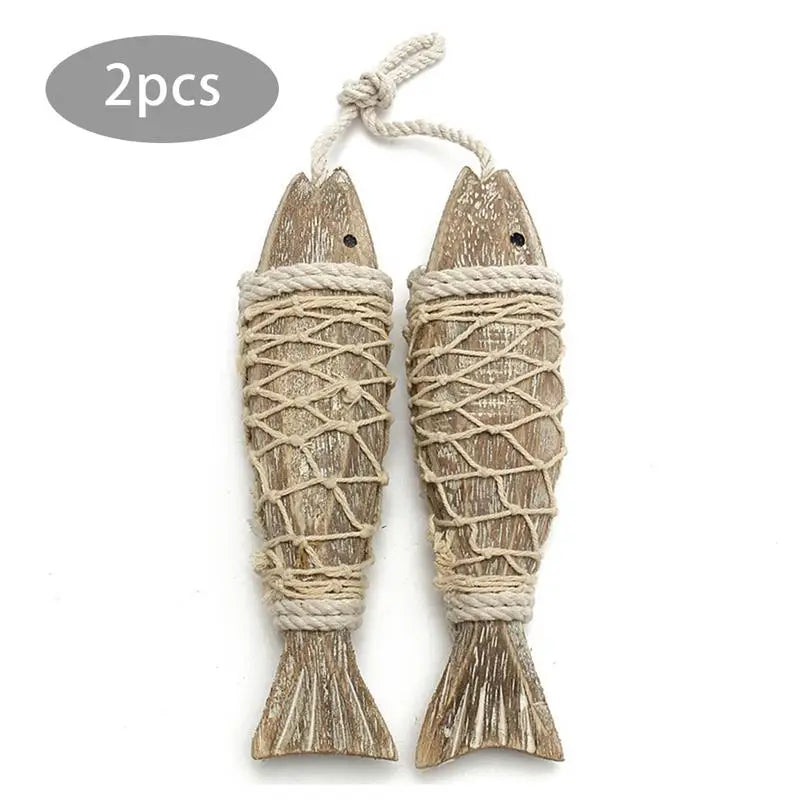 Two wooden fish-shaped decorations with rope on a white background