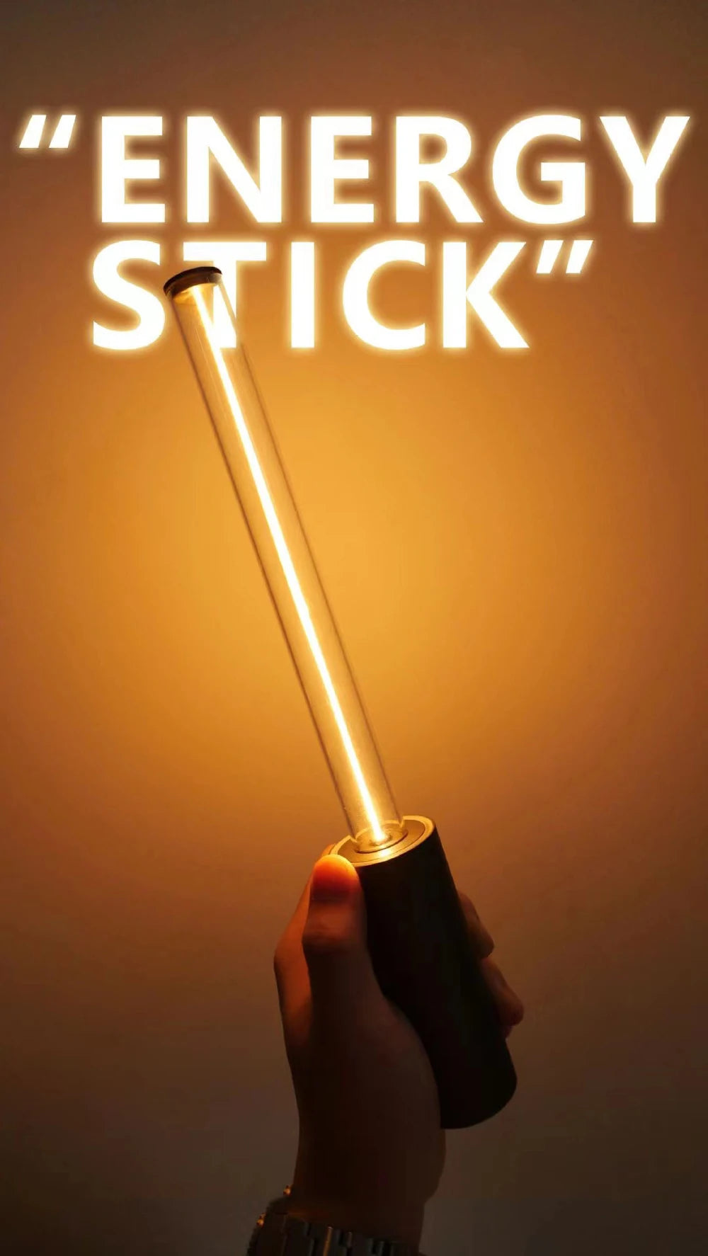 Hand holding a glowing 'ENERGY STICK' against a warm background