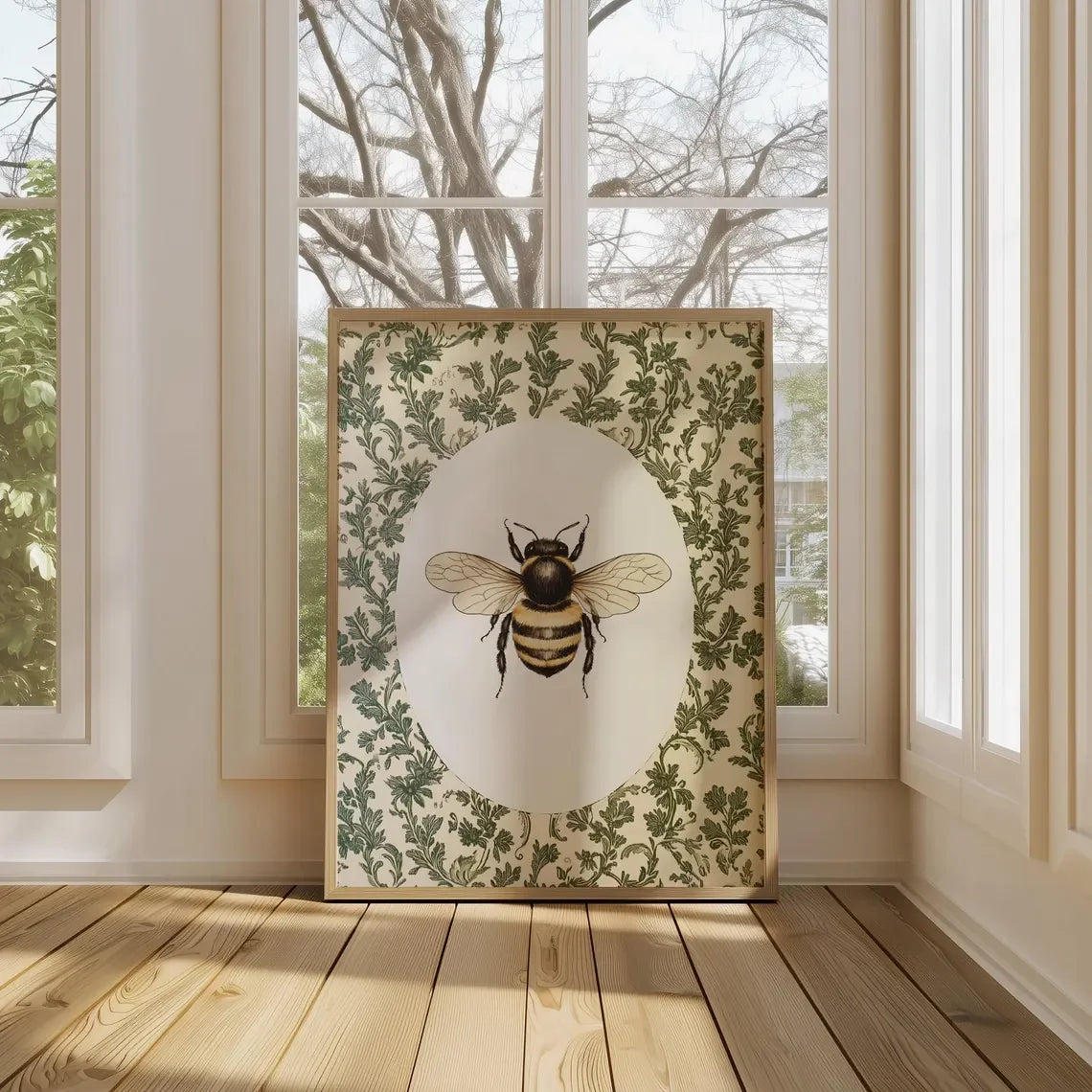 Framed artwork of a bee with floral patterns in a room with large windows.