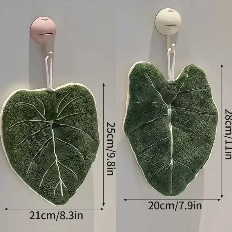 Two green leaf-shaped hooks with measurements on a white background