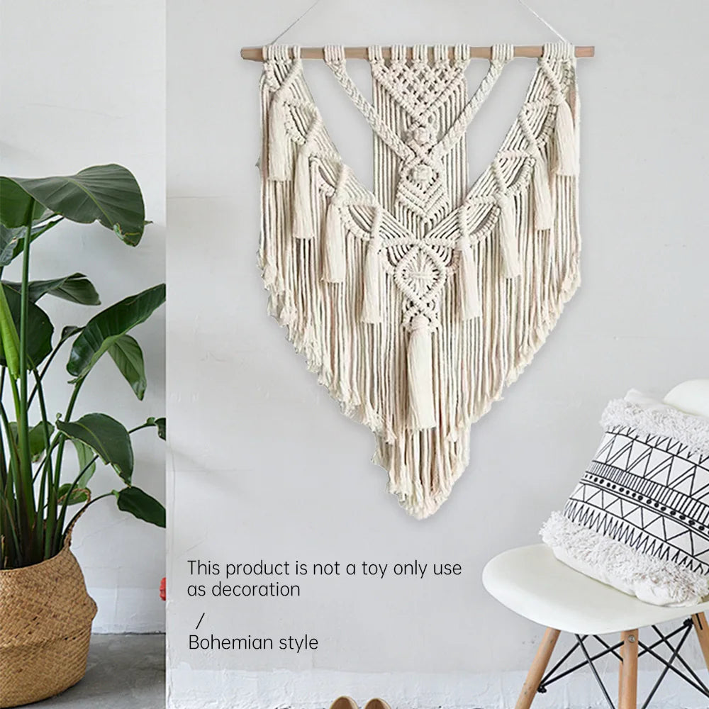 Macrame wall hanging on a white wall with a plant and chair in the background