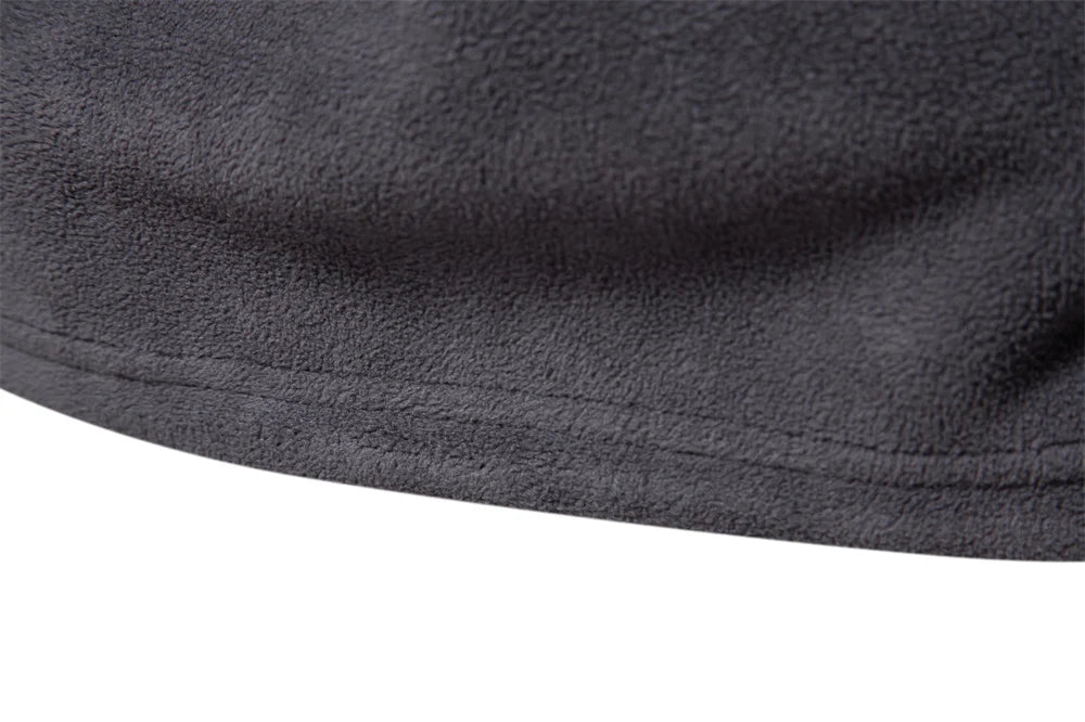 Close-up of dark gray fleece fabric on a white background