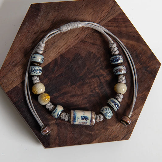 Handmade blue ceramic bead bracelet with adjustable rope and tube centre bead