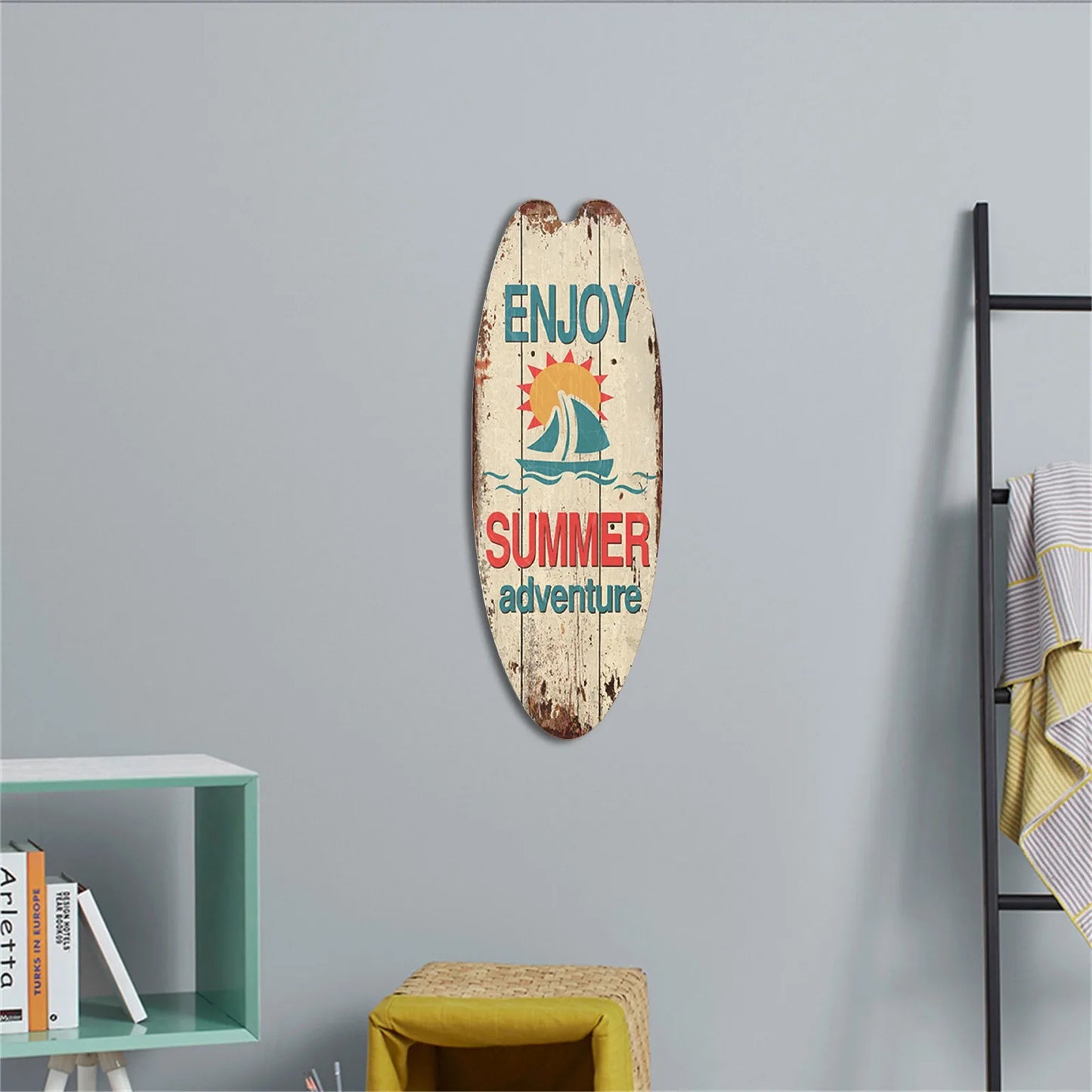 Decorative surfboard with 'Enjoy Summer Adventure' text on a gray wall.