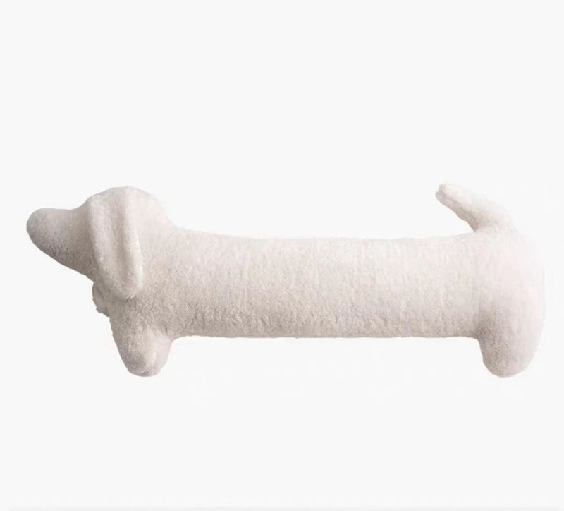 White dog-shaped cushion on a white background