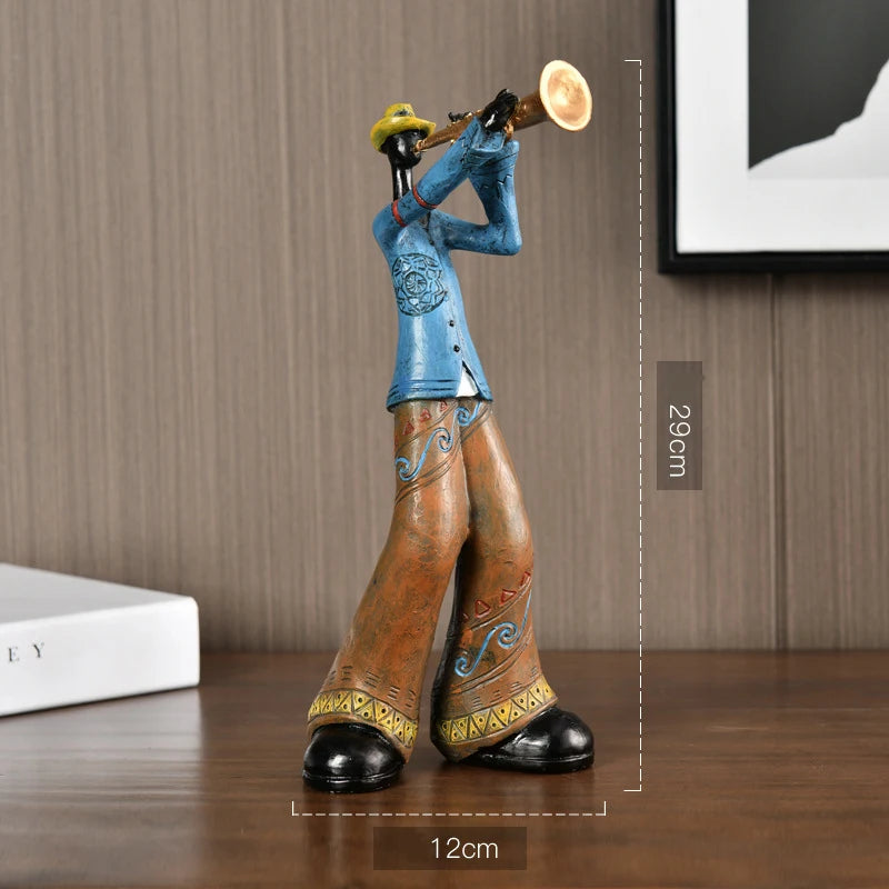 Decorative figurine of a person in a blue top and brown pants playing a horn on a wooden surface with measurements indicated.