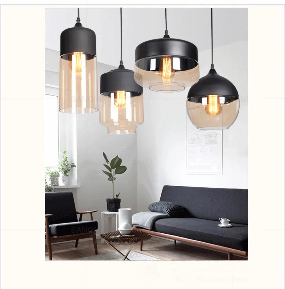 Modern pendant lights hanging in a living room setting with a sofa and chair.