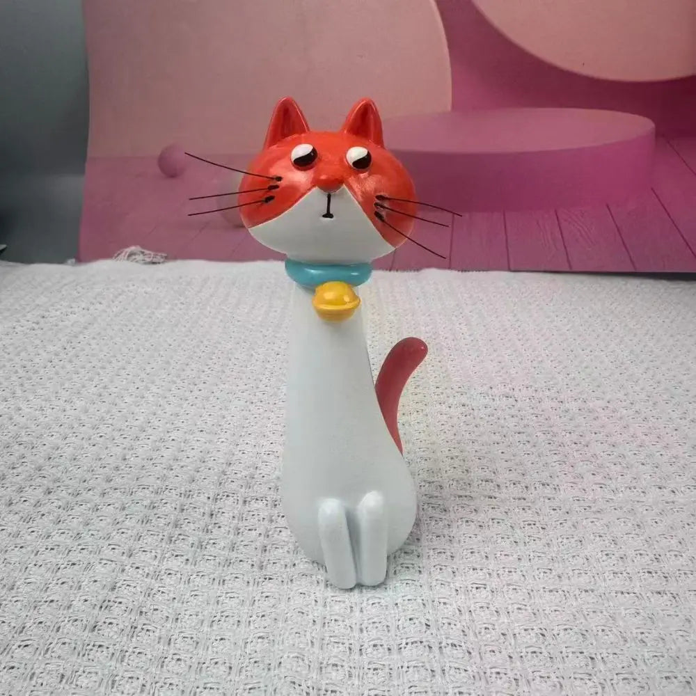 Cat-shaped vase with a yellow ball on a textured surface