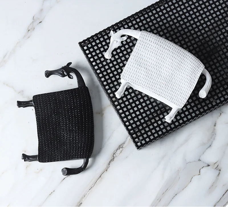 Abstract armoured horse sculpture in black and white resin with textured decorative armour, modern contemporary ornament for home decor.