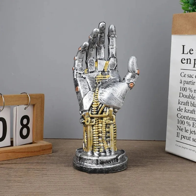 Mechanical hand sculpture on a wooden surface with a calendar and text in the background