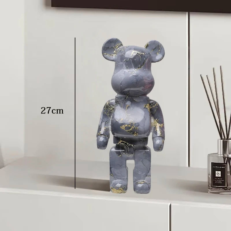 Gray marble-patterned bear figure on a white surface with a diffuser in the background
