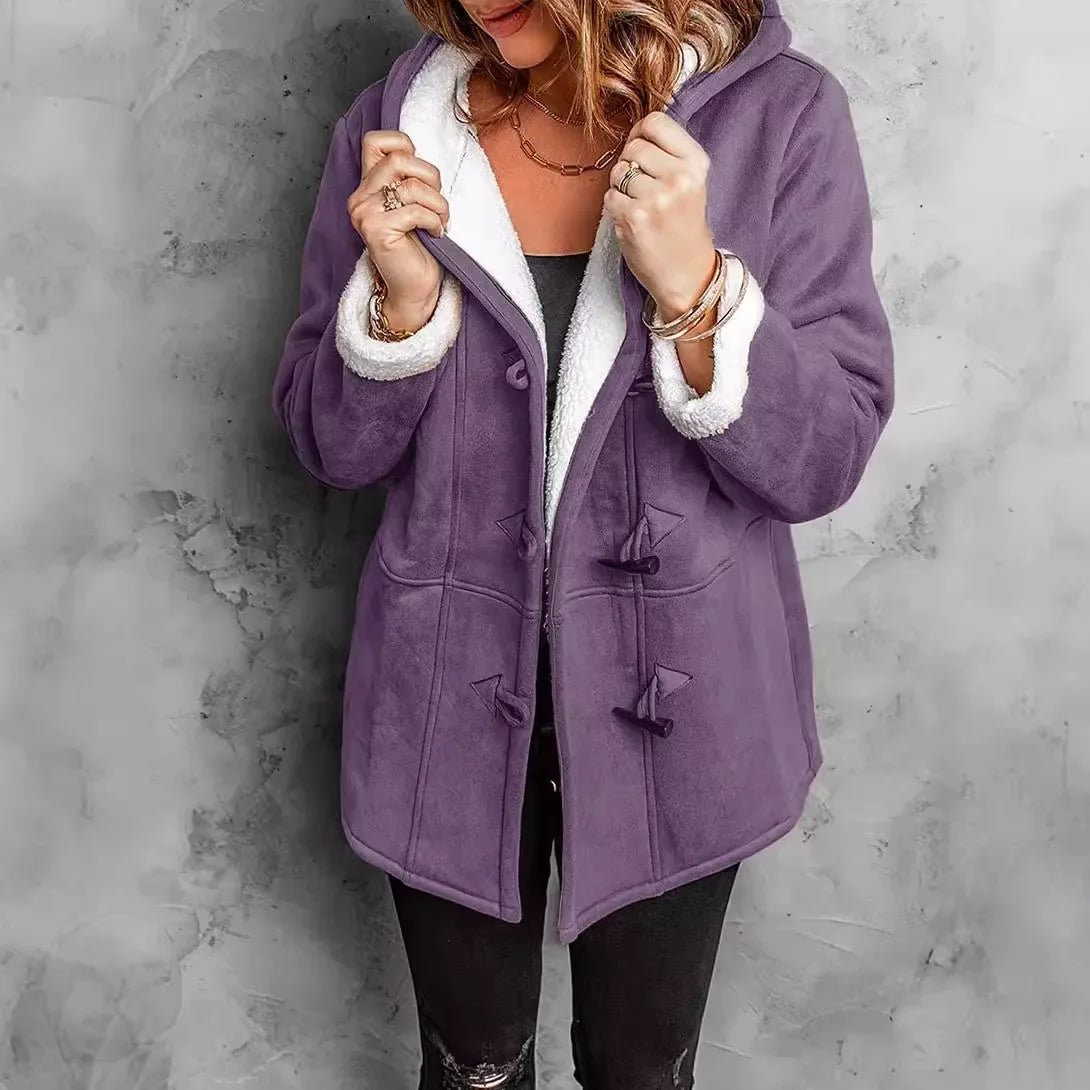 Person wearing a purple coat with white lining against a gray background