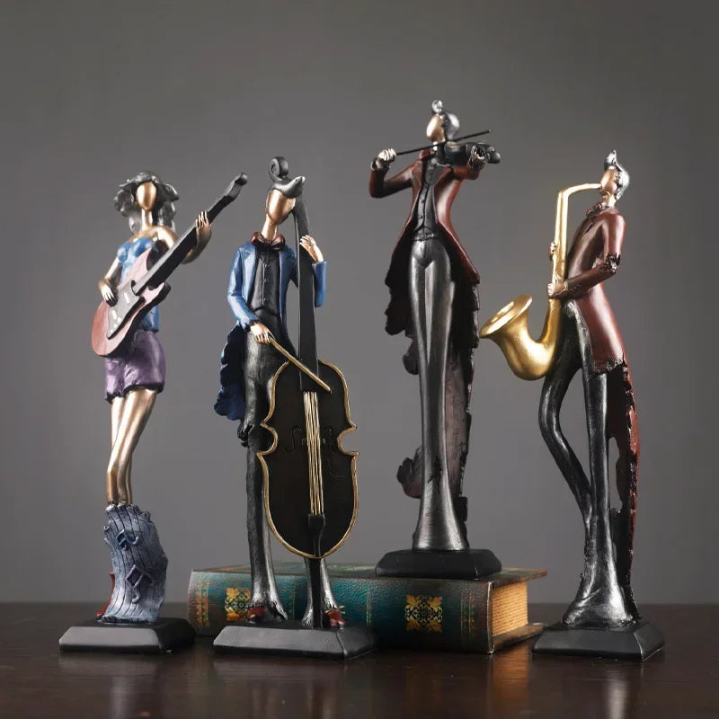 Four musical instrument figurines on a wooden surface with a gray background