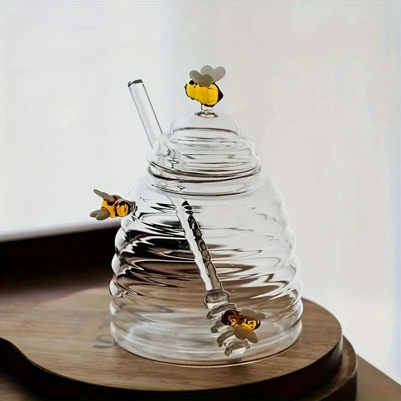 Clear glass honeycomb with bee decorations on a wooden surface