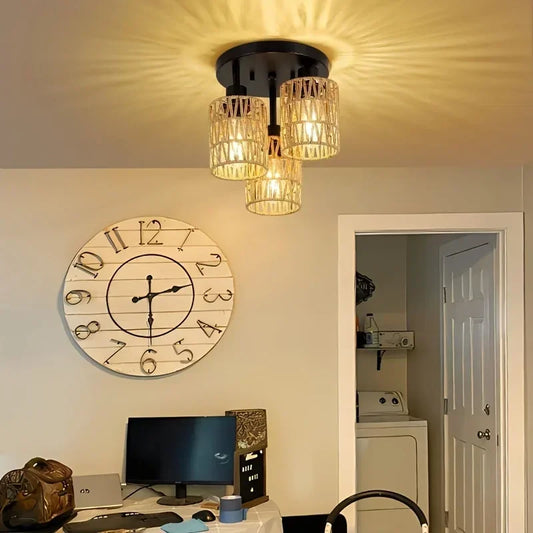 Ceiling light fixture in a room with a clock and computer setup.