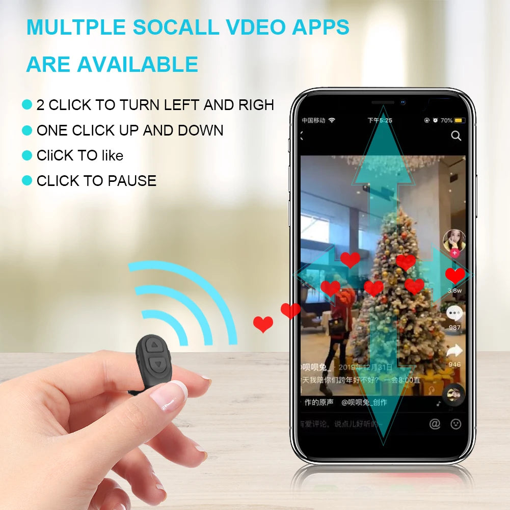Hand holding a remote control with smartphone displaying social video app interface on a blurred indoor background.