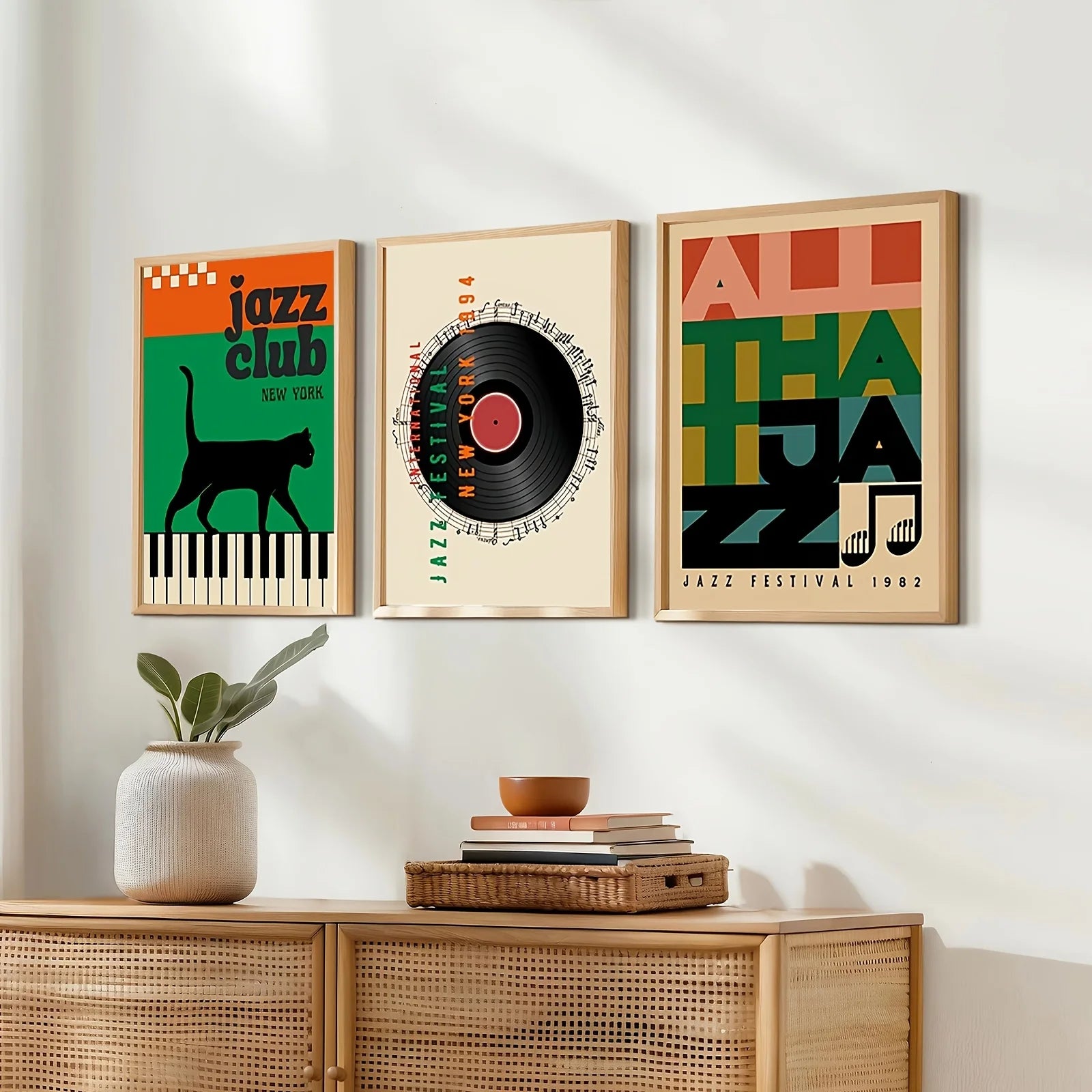 Three framed jazz-themed posters on a wall above a wooden cabinet.