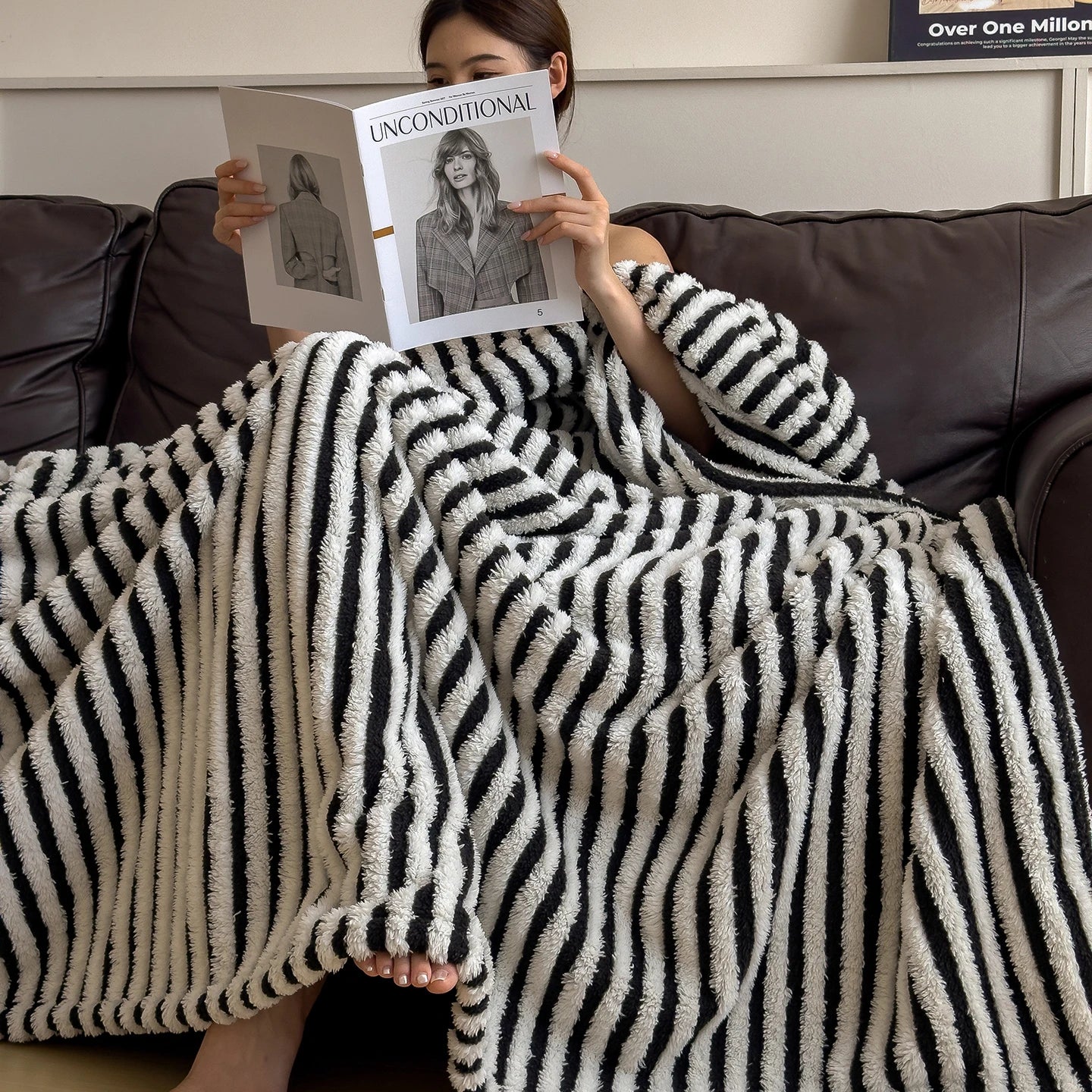 Soft striped plush fleece blanket draped over sofa in neutral tones cosy home decor