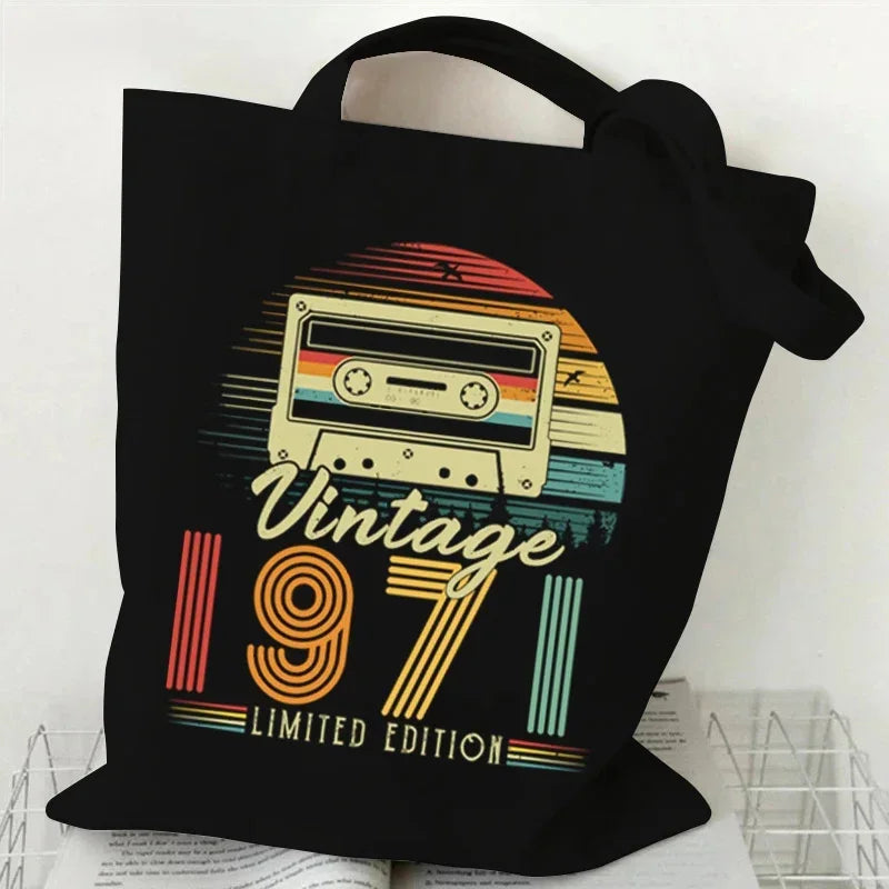 Black tote bag with a retro cassette design and 'Vintage 1971 Limited Edition' text on a white background.