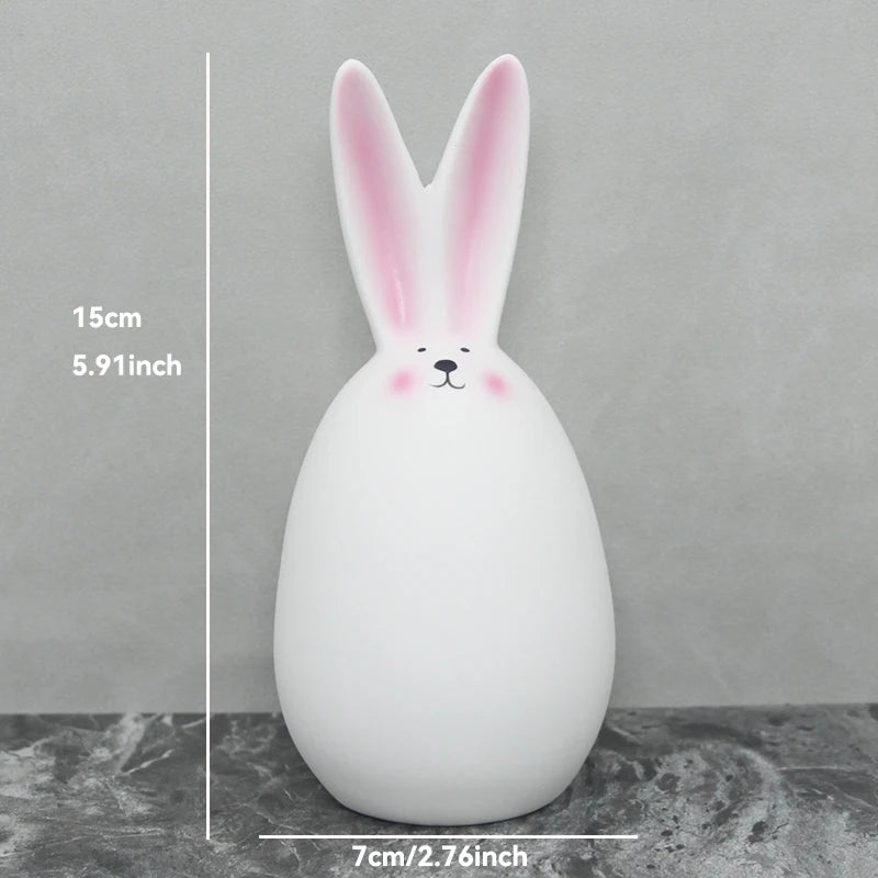 White rabbit-shaped ornament with measurements on a gray background
