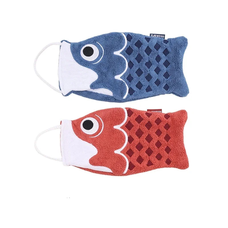 Two fish-shaped hand towels, one blue and one red, on a white background