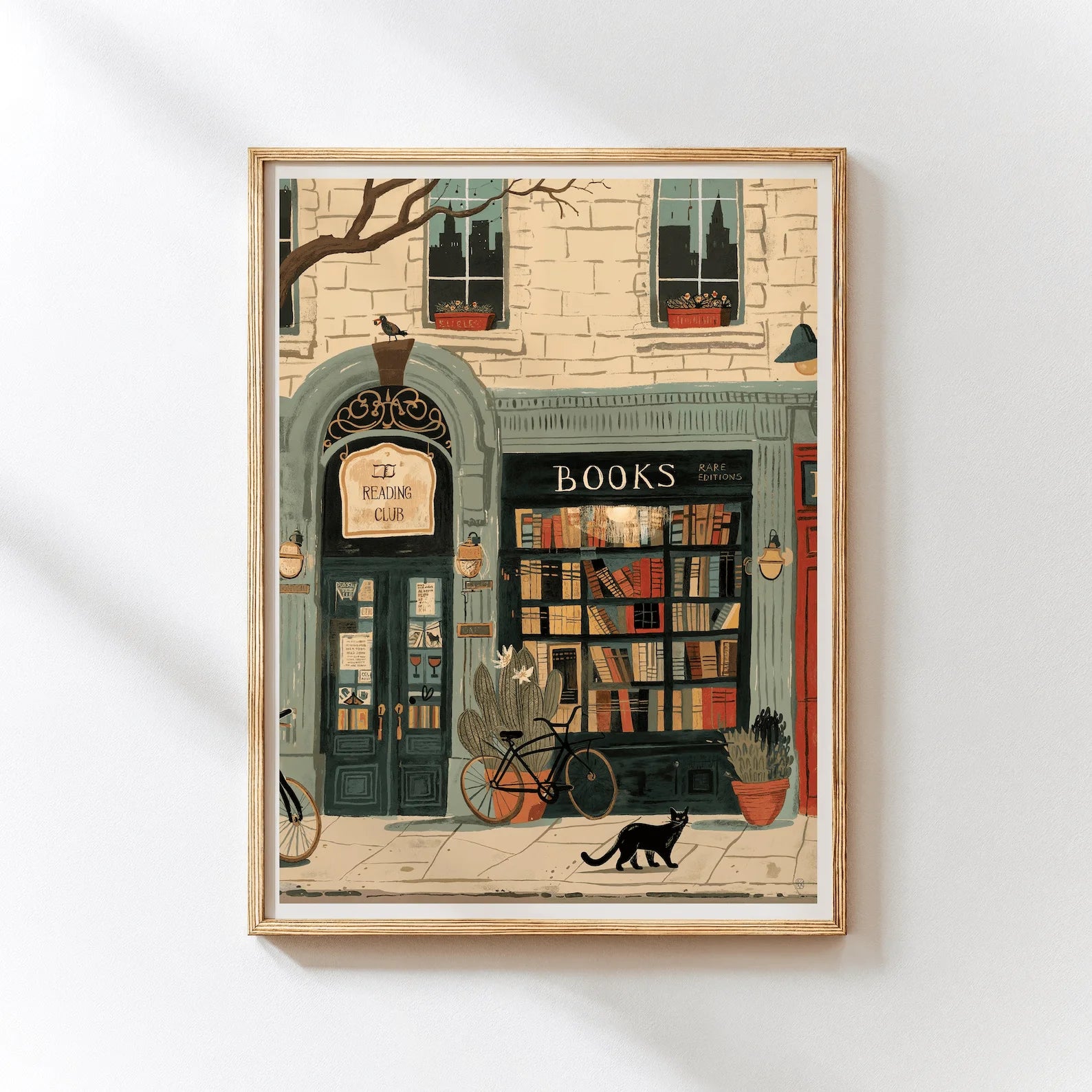 Framed artwork of a bookshop with a cat on a white wall
