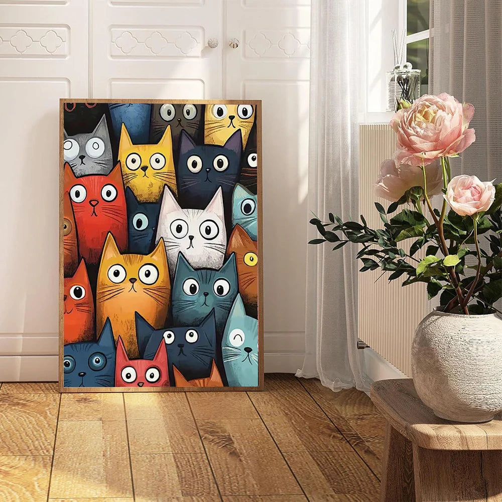 Colorful cat-themed wall art on a wooden floor with a vase of flowers in the background.