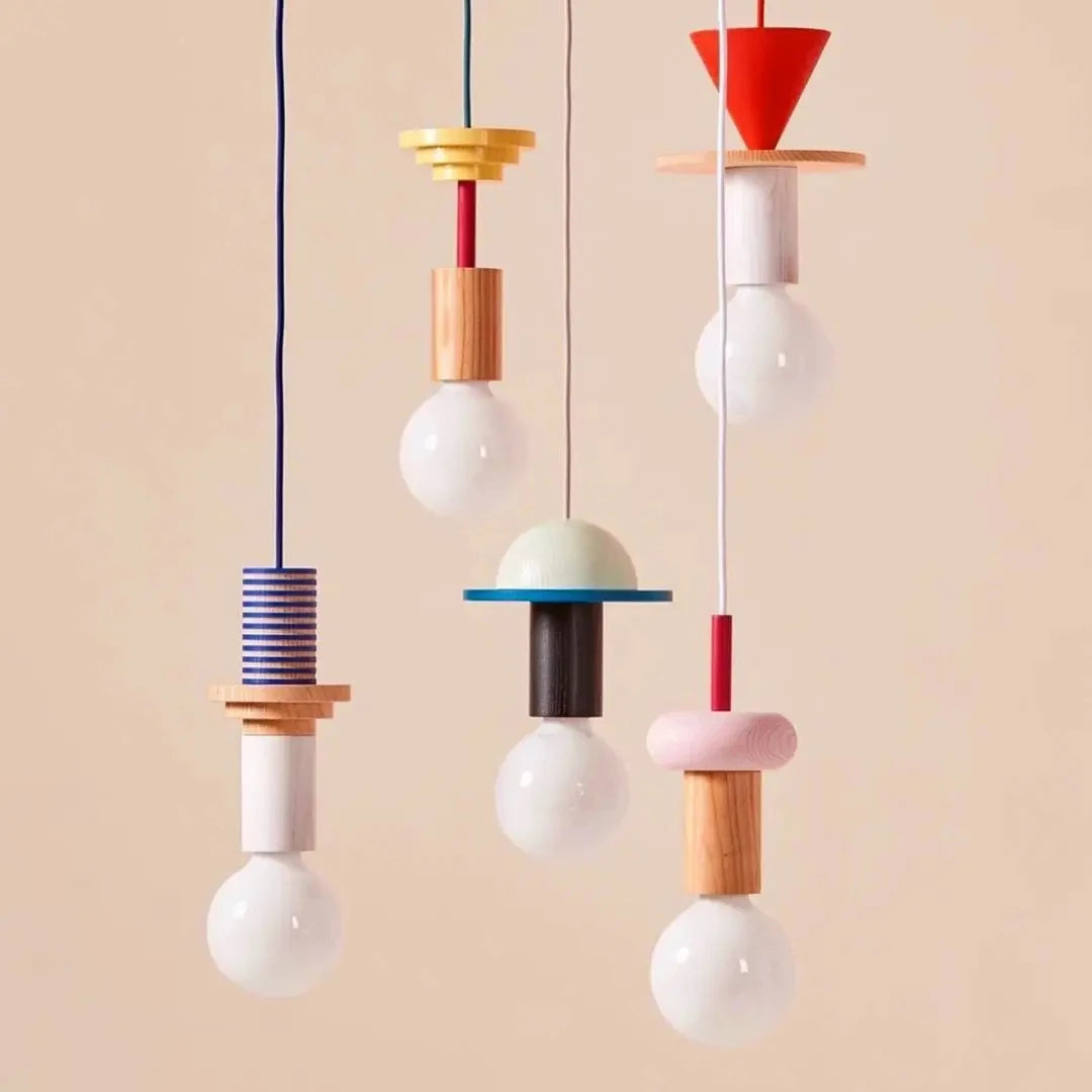 Colorful pendant lights with geometric designs on a beige background