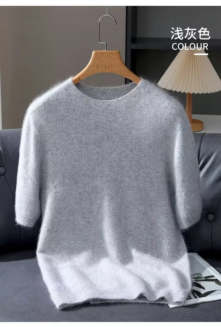 Gray sweater on a hanger against a neutral background
