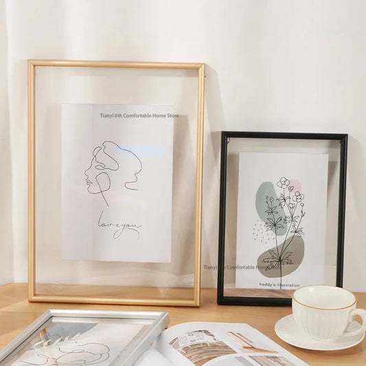 Framed artwork on a table with a cup and saucer