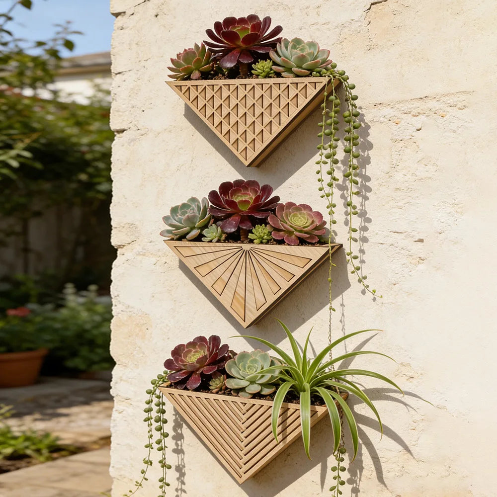 Three triangular wooden planters with succulents on a stone wall