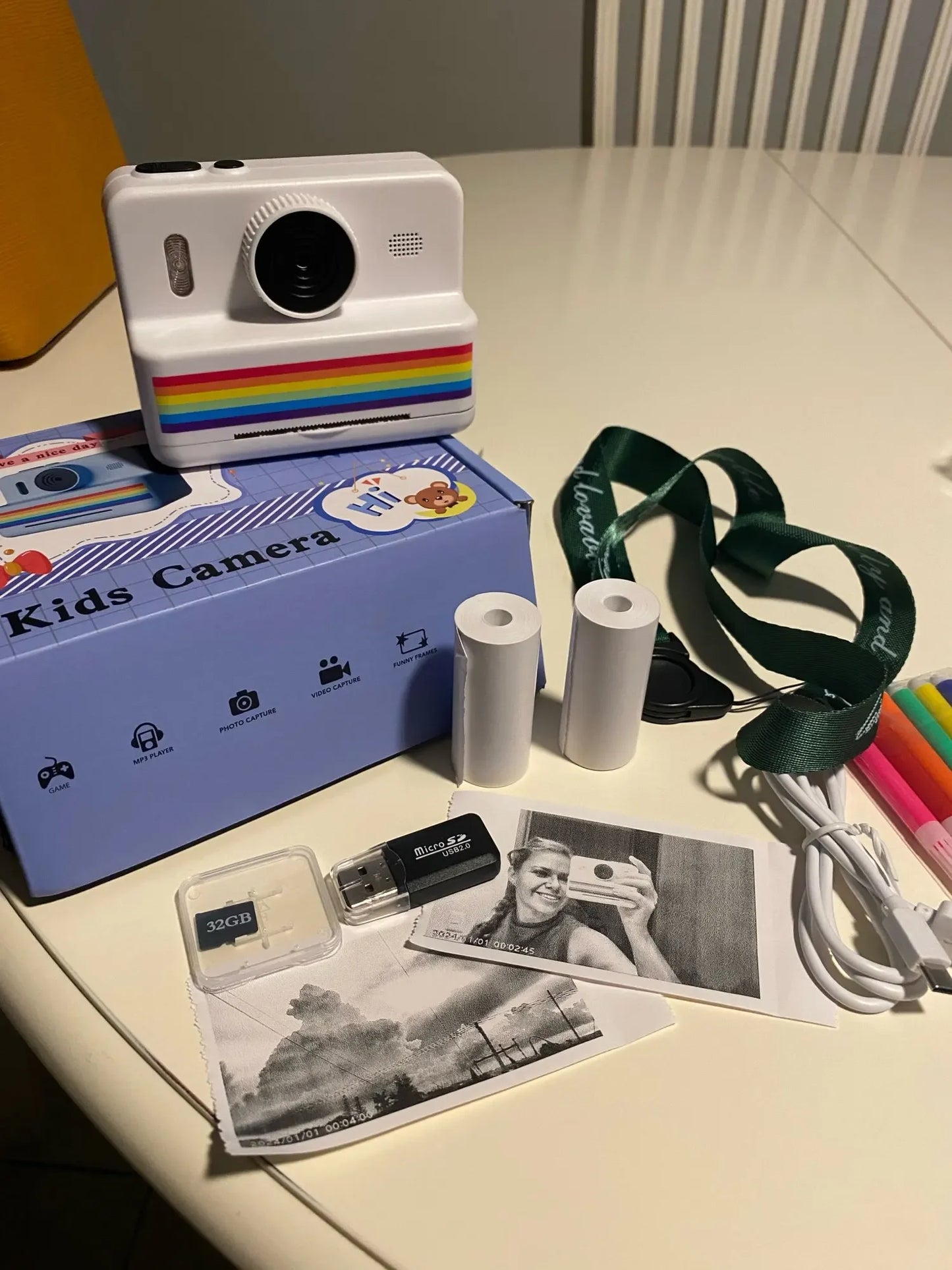 White kids camera with accessories on a table