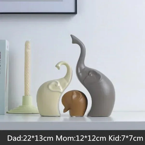Three elephant-shaped decorative items on a shelf with size labels.